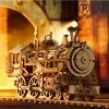 A detailed wooden model of a steam locomotive is displayed on a track, with a warm, atmospheric background suggesting a tunnel or industrial setting. Náhľad obrázku produktu