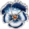 A close-up studio shot of a Pandora charm shaped like a blue and white pansy flower with a small orange gem in the center. Anteprima dell’immagine prodotto
