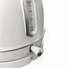 Close-up of a cream-colored electric kettle, focusing on the water level indicator and the power switch. Produktbild-Vorschau