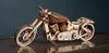A wooden model of a motorcycle is displayed on a dark surface with a dark background. Anteprima dell’immagine prodotto
