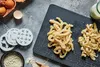 A top-down view of ingredients and tools for making homemade pasta, including eggs, flour, a pasta maker, and freshly made pasta. Produktbild-Vorschau