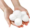 Hands holding a pile of white filter balls. Produktbild-Vorschau