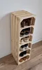 A wooden shoe rack made of stacked crates, filled with various shoes. Produktbild-Vorschau