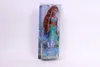 A doll in its packaging, displayed against a white background. Voir les images du produit