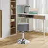 A gray upholstered stool is placed next to a white desk with a laptop and a desk lamp. Produktbild-Vorschau