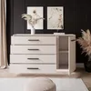 A modern dresser with an open cabinet, decorated with dried flowers and artwork, in a stylish room setting. Produktbild-Vorschau