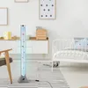 A bubble lamp with fish is placed on a striped rug next to a child's bed in a room. Produktbild-Vorschau
