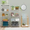 A studio shot of two stainless steel shelving units with various decorative and functional items. Náhled obrázku produktu