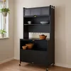 A black kitchen cabinet with shelves and drawers, placed in a room with a window and a hanging plant. Anteprima dell’immagine prodotto