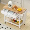 A white kitchen cart with a wooden top, filled with kitchen items like dishes, fruit, and a coffee maker. Náhled obrázku produktu