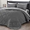 A bed with a comforter and pillows. Produktbild-Vorschau