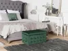 A bedroom scene with a bed, a console table, and a storage ottoman. Produktbild-Vorschau