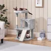 Two cats are playing on a multi-level cat tree in a living room setting. Podgląd zdjęcia produktu