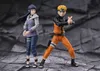 Two anime action figures, Naruto and Hinata, standing in a dynamic pose against a rocky, grey background. Náhled obrázku produktu
