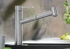 A modern kitchen faucet with a pull-out spray head is shown in a close-up shot, set against a textured backsplash and countertop. Produktbild-Vorschau