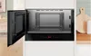 An open Bosch built-in microwave oven is shown in a modern kitchen setting. Voir les images du produit