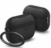 Two black fabric-covered cases for wireless earbuds, one in the foreground with a metal ring attached, and another in the background. Produktbild-Vorschau