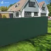 A green privacy screen fence is installed in front of a modern house with a lawn. Anteprima dell’immagine prodotto