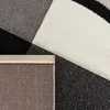 A close-up view of a rug with a geometric pattern, showing the texture and backing. Anteprima dell’immagine prodotto