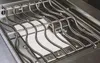 A close-up view of a grill grate over a ceramic heating element. Produktbild-Vorschau