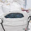Several large white bags filled with shredded plastic material, with one bag in the foreground filled with black and blue shredded plastic. Produktbild-Vorschau