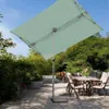 An outdoor patio scene with a rectangular umbrella providing shade over a table and chairs. Produktbild-Vorschau