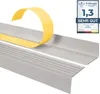 A close-up view of a gray stair nosing profile with yellow adhesive tape being peeled off, and a product rating badge in the upper right corner. Anteprima dell’immagine prodotto