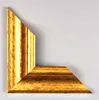 A corner piece of a gold picture frame with an antique finish is shown against a plain light gray background. Produktbild-Vorschau