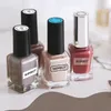 Several bottles of nail polish are arranged on a surface. Podgląd zdjęcia produktu
