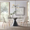 A dining room scene with a round table and four chairs, a chandelier, and a framed map on the wall. Náhľad obrázku produktu
