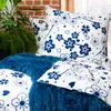 A close-up view of bedding with a floral pattern. Produktbild-Vorschau