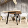 A dining table with chairs in a cozy room with a fireplace. Voir les images du produit