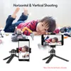 A child is lying on the floor surrounded by toys, with two smartphones on tripods in the foreground, demonstrating horizontal and vertical shooting. Produktbild-Vorschau
