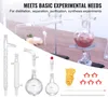 A collection of laboratory glassware and equipment for distillation and other experiments, set against a blurred background of a laboratory setup. Produktbild-Vorschau