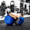 A man is doing sit-ups with a blue exercise ball in a gym. Voir les images du produit