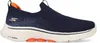 A side view of a navy blue Skechers Go Walk 7 sneaker with orange accents. Anteprima dell’immagine prodotto