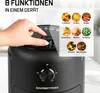 A hand is shown turning a dial on a black air fryer, with a graphic overlay displaying various food icons and their corresponding functions. Produktbild-Vorschau