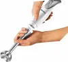 Hands assembling a white and silver immersion blender. Produktbild-Vorschau