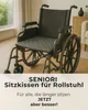 A wheelchair with a seat cushion in a room. Produktbild-Vorschau