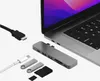 A USB-C hub and accessories are laid out next to a laptop. Produktbild-Vorschau