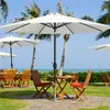 Outdoor seating area with umbrellas and tables by the ocean. Produktbild-Vorschau