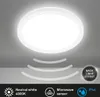 A white LED ceiling light with a microwave sensor, shown on a light gray ceiling. Produktbild-Vorschau
