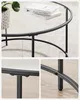 A coffee table with a glass top and a black metal frame, shown with close-up details of its construction. Náhled obrázku produktu