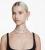 A woman wearing multiple Swarovski necklaces and earrings. Produktbild-Vorschau