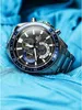 A close-up shot of a Casio Edifice watch resting on a blue fabric. Anteprima dell’immagine prodotto