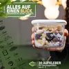 A hand holding a clear plastic food container filled with muesli, with a green background featuring text and illustrations of food items. Anteprima dell’immagine prodotto