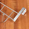 Close-up of a metal rack on a wooden surface. Produktbild-Vorschau