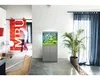 A modern living room with an aquarium and a person walking by. Produktbild-Vorschau