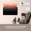 A black glass panel heater is mounted on a wall, with red heat waves emanating from the top. Icons indicating features are displayed on the wall to the right, and a chair with a blanket and pillow is visible to the right. Produktbild-Vorschau