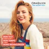 A woman smiling outdoors with a city and ocean in the background. Produktbild-Vorschau